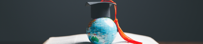 A globe with a graduation hat